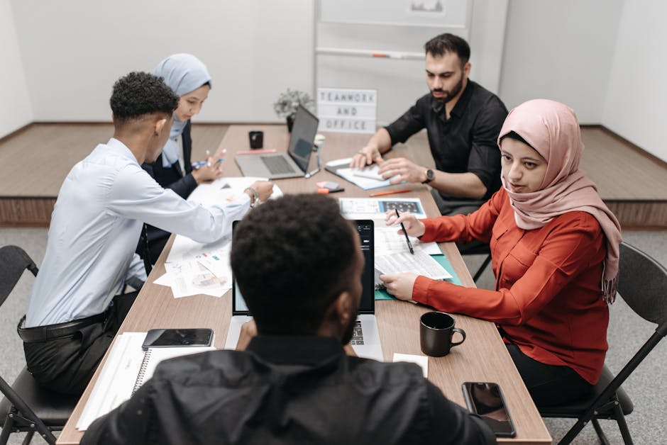 A diverse team of coworkers engaged in a productive meeting at a modern office conference table