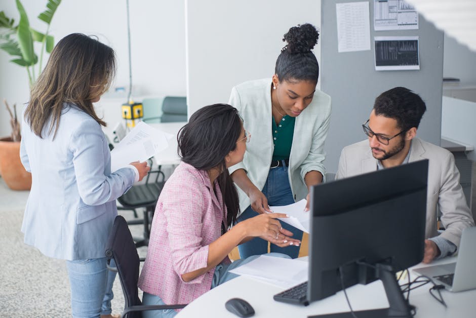A diverse team engaged in a lively discussion in a modern office setting, fostering collaboration and teamwork