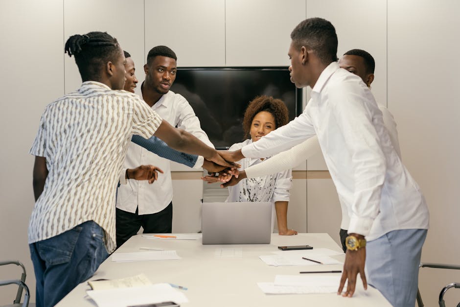 Group of professionals collaborating in an office setting, emphasizing teamwork and unity