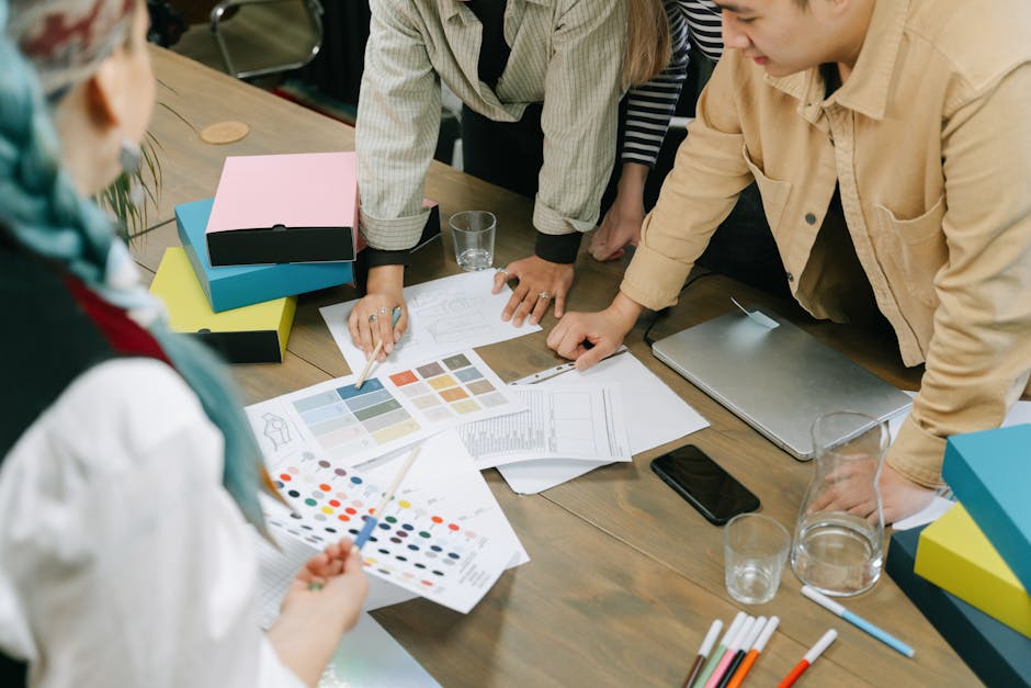 Creative professionals engaged in a design meeting, sharing ideas and color schemes